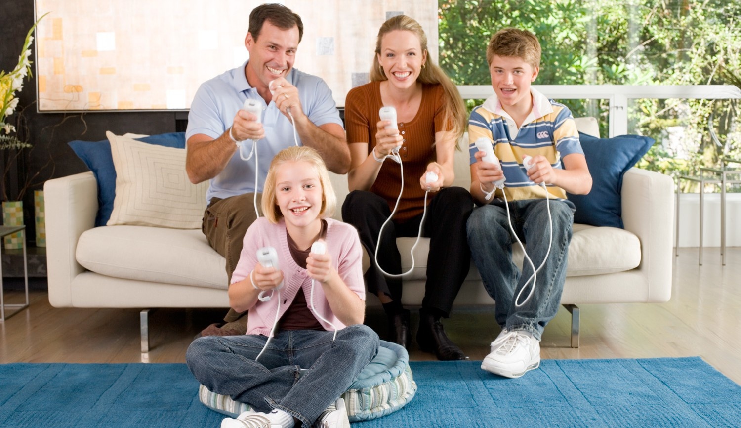 A marketing photo of a family playing Wii together.