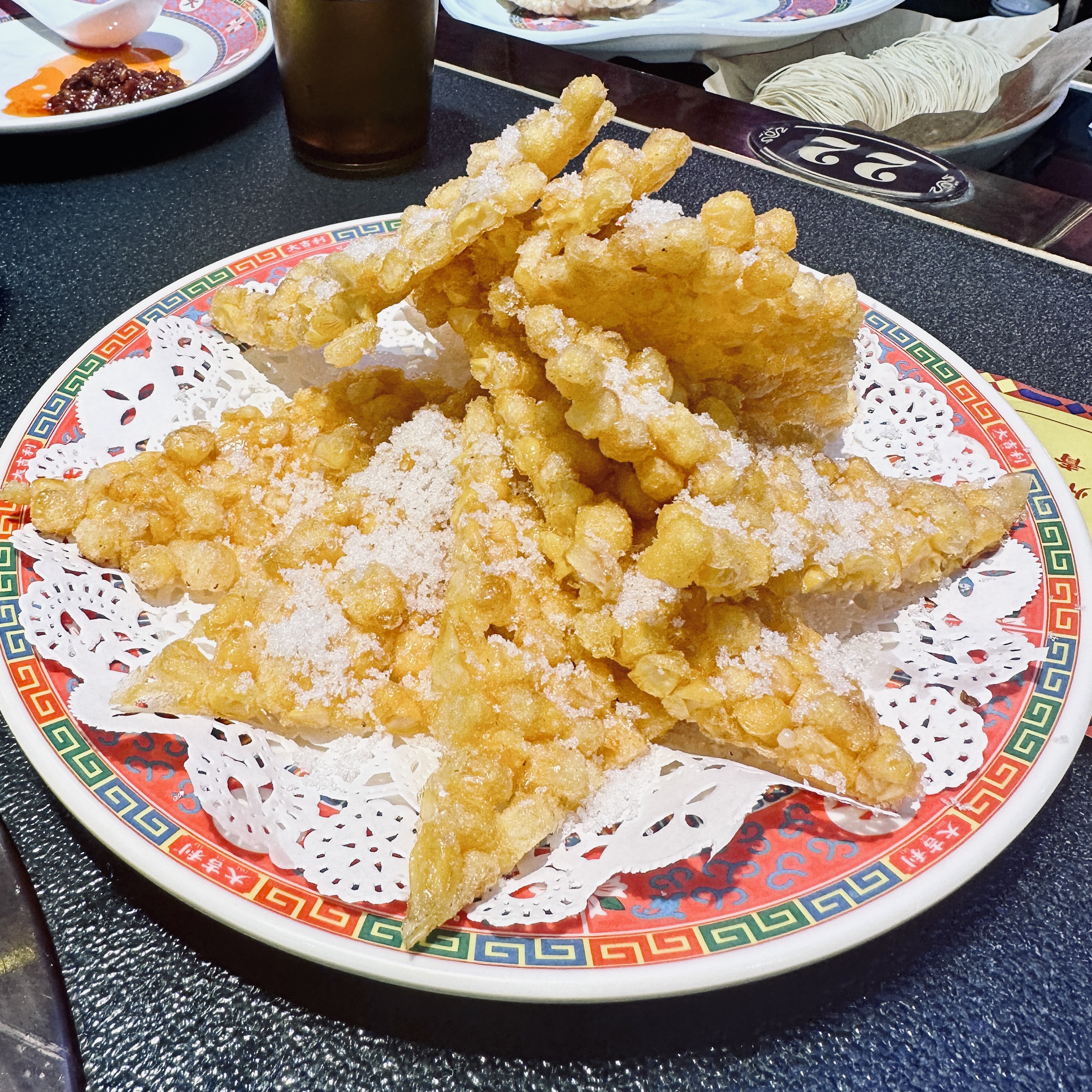 A photo of yumi lao, which looks like like (and is) a sugary mass of fried corn.